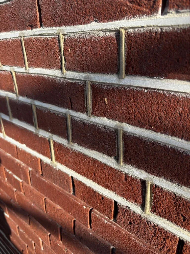 Close-up strak uitgeslepen snijvoeg op rode baksteen